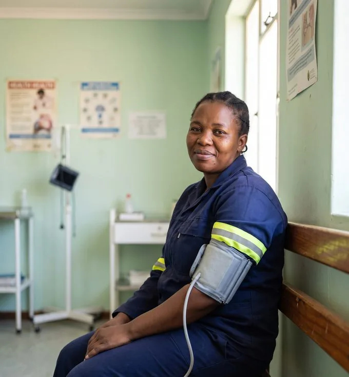 A worker having blood pressure measured